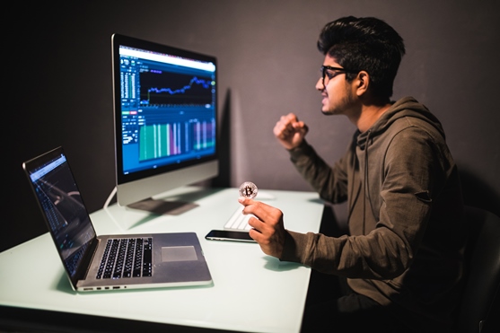 indian-trader-with-bitcoin-checking-stock-trading-data-analysis-concept-working-office-with-financial-graph-computer-monitors